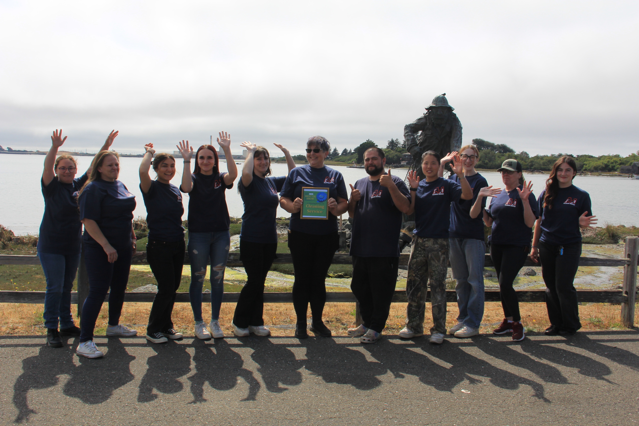 A‑1 Cleaning Service maid team posing together outdoors near the Eureka waterfront.