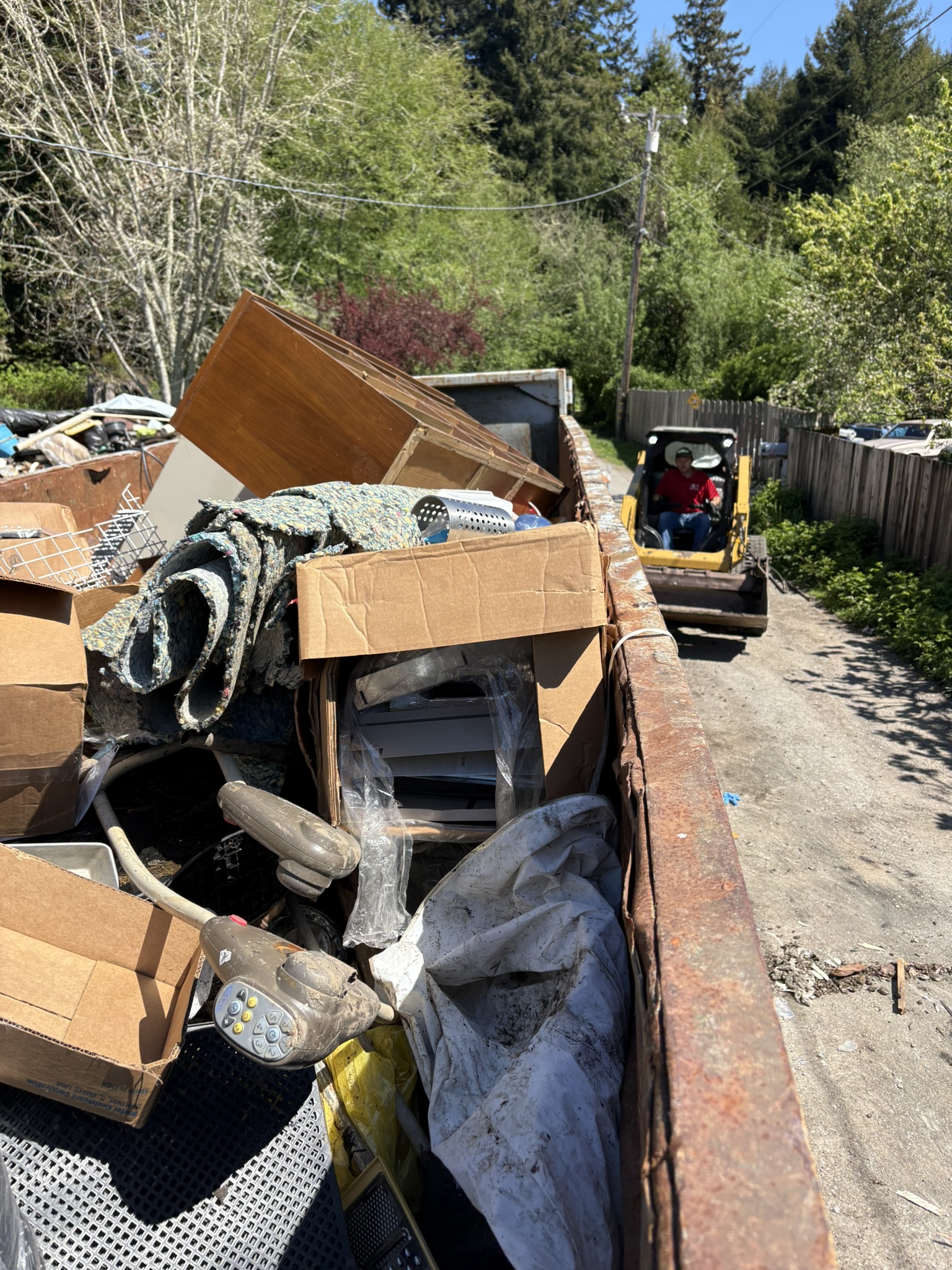 40 yard dumpster and skid steer used during hoarder cleanup and junk hauling project in Fortuna, CA