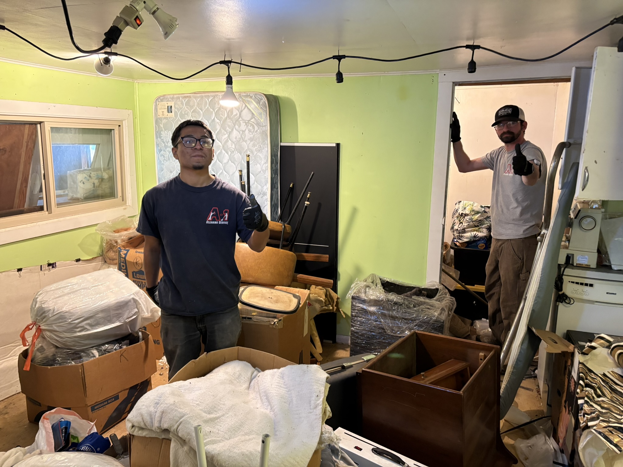 Hoarder cleanup and junk hauling, showing team clearing interior space in Fortuna, CA